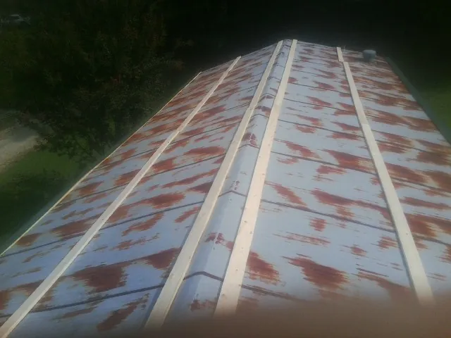 Rusted metal roof panels with new wood purlins before replacement — Storm Damage Roof Repair in Firth by Roofing Brothers
