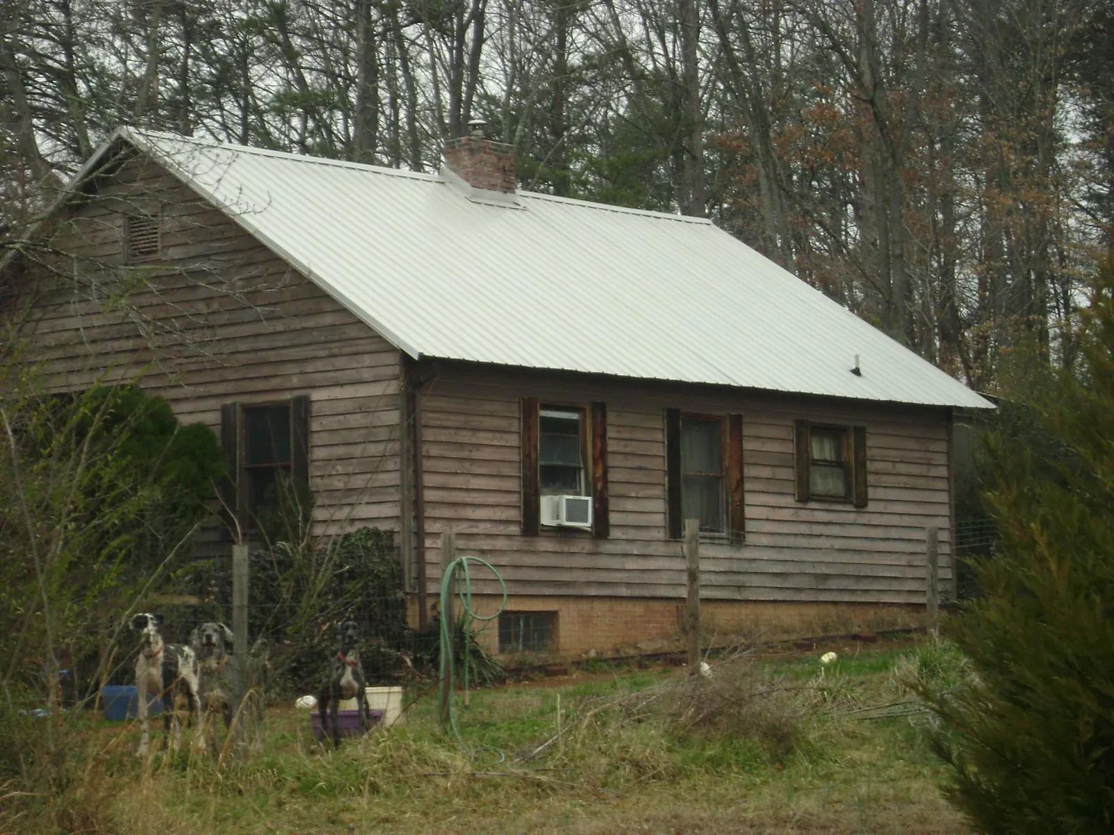 White metal roof on an old wood sided farmhouse, from a Metal Roof Installation job in Firth